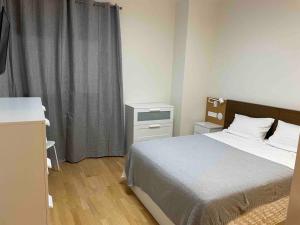 a small bedroom with a bed and a window at VIP Suites in Murcia +66 photos