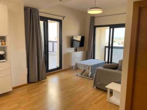 a living room with a couch and a table at Apartamento Vips Suites in Murcia