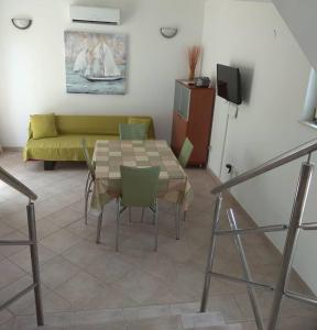 a living room with a table and a couch at Holiday home Penić in Rogoznica