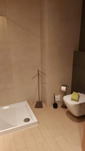 a bathroom with a white tub and a toilet at The Roof Praia da Rocha in Portimão