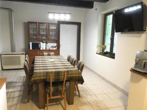 a kitchen and dining room with a table and chairs at Vadászház in Rádócújfalu