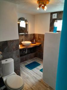 a bathroom with a white toilet and a sink at Casa Lantana in Figueira da Foz
