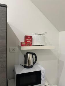 a tea kettle on top of a microwave at Apartma Azurre in Postojna