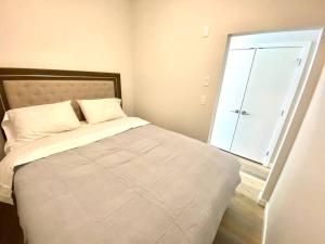 a bed in a room with a large window at Lovely Brand New Suite in Sidney