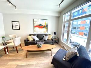 a living room with a couch and a table at Lovely Brand New Suite in Sidney