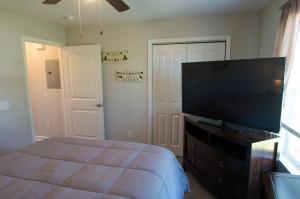 a bedroom with a bed and a flat screen tv at Pet-Friendly, GREAT Guest Suite with Private Entry & Deck! ONLY 25 Mins from Downtown Nashville! in Ashland City