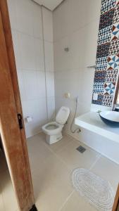 a bathroom with a toilet and a sink at Orla Graciosa in Palmas +5 photos
