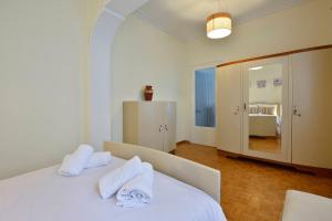 a bedroom with a white bed with towels on it at Gardenia Suite Corfu Town in Corfu
