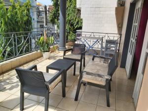 a group of chairs and tables on a balcony at MC Location in Abidjan