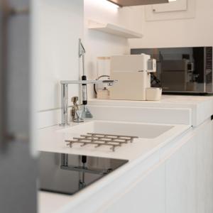 a kitchen with a counter with a stove top at Il Mama House in Termoli