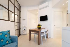 a living room with a table and a blue couch at Il Mama House in Termoli