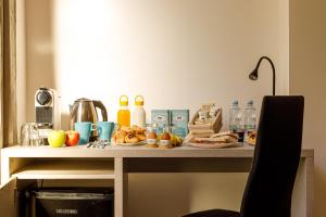 a table with food and drinks on top of it at Catone Luxury Rooms in Rome
