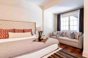 a bedroom with a large bed and a couch at *New* Bourbon City Luxury Guest House in Louisville