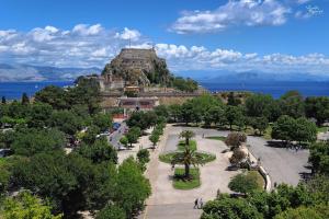 a view of a park with a mountain in the background at Gardenia Suite Corfu Town in Corfu
