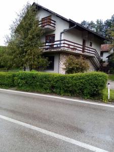 a house with balconies on the side of a road at Kecman in Drvar