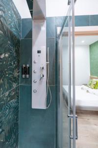 a shower with a glass door in a bedroom at Catone Luxury Rooms in Rome