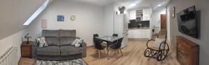 a living room with a leather chair and a table at El Ático de la Estación in Oviedo +17 photos
