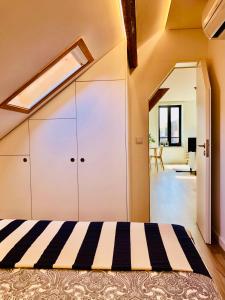 a bedroom with a large white closet with a skylight at Matosinhos Beach Loft in Matosinhos