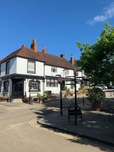 a white building with a stop sign in front of it at Lovely Two Bedroom Town House - Minimum 2 Night Stay in Midhurst