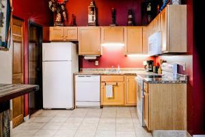 a kitchen with wooden cabinets and white appliances at Pet-friendly Canal Park Condonear Lakewalk Pool in Duluth