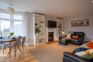 a living room with a table and a dining room at Entire home in Streatham with lovely views & ultra fast Wi-Fi in Norbury