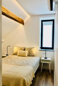 a bedroom with a bed and a window at Matosinhos Beach Loft in Matosinhos