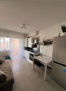 eine Küche und ein Wohnzimmer mit einem Sofa und einem Tisch in der Unterkunft Casa al mare in Cogoleto