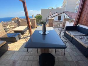 a table with a vase on top of a balcony at Adamas Domus in Taormina