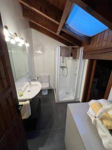 a bathroom with a sink and a shower at Ático en Llivia in Llivia
