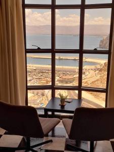 a room with a large window with a table and chairs at Al-marsa2 in Al Hoceïma