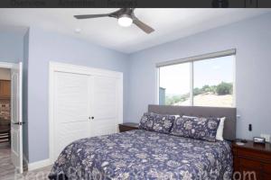 a bedroom with a bed and a ceiling fan at Hillside view with hot tub too in Arroyo Grande