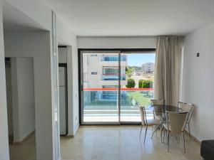 a dining room with a table and a large window at Cozy and Peaceful Apartment In the Belek Center in Belek