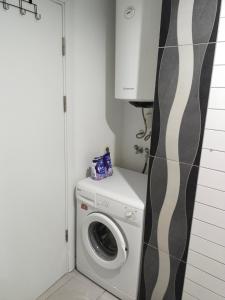 a washer and dryer in a laundry room with a cabinet at Cozy and Peaceful Apartment In the Belek Center in Belek