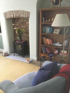 a living room with a couch and a fireplace at Belmont Gem in Knaresborough