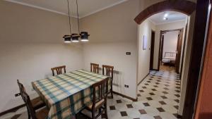 a dining room with a table and four chairs at Casa Sole in Morgex