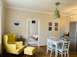 a kitchen and dining room with a table and chairs at Apartmány Chmelničky in Protivín