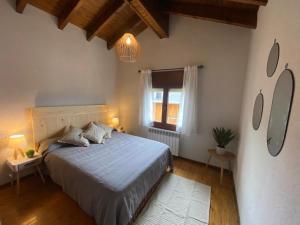 a bedroom with a large bed and a window at Ático en Llivia in Llivia