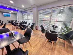 a waiting room with tables and chairs in a restaurant at Hotel Lido in Athens