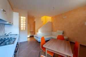 a kitchen and dining room with a table and a couch at Gratteri Holiday Appartamento Rapi Pitittu in Gratteri +39 photos