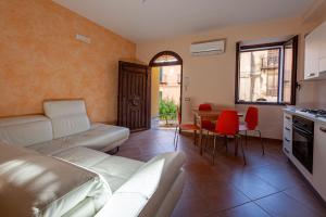 a living room with a couch and a table at Gratteri Holiday Appartamento Rapi Pitittu in Gratteri