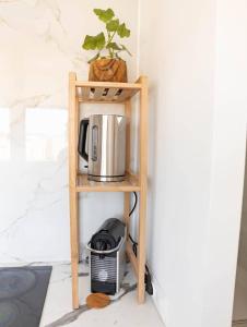 a shelf with a coffee maker and a microwave on it at Studio / 15min de la plage in Fréjus