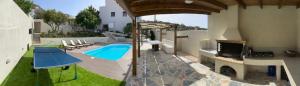 an image of a backyard with a swimming pool at Seafront Villa Nefeli in Keratea