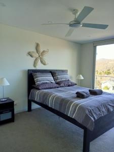 a bedroom with a bed with a flower on the wall at Snowhaven in Jindabyne