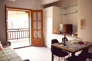 a kitchen with a table with a bottle of wine on it at Iris House in Ierissos