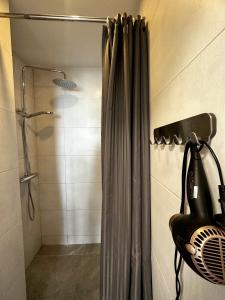 a shower with a shower curtain in a bathroom at panoramic view and free parking in Vilnius