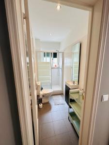 a bathroom with a sink and a toilet and a mirror at Rooms to rent in a friendly apartment in Lisbon
