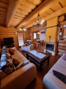 a large living room with couches and a fireplace at Zrub Kaška in Čadca