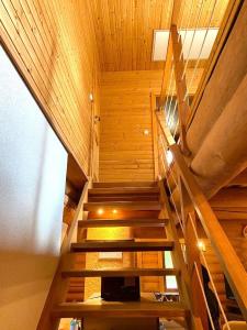 a staircase in a room with wooden walls and ceilings at Zrub Kaška in Čadca