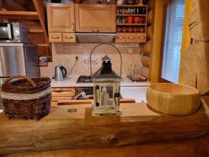 a kitchen with a counter with a lantern on it at Zrub Kaška in Čadca
