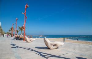 a beach with some white whale sculptures on it at Cozy Apartment In Vinaroz With Kitchen in Vinarós